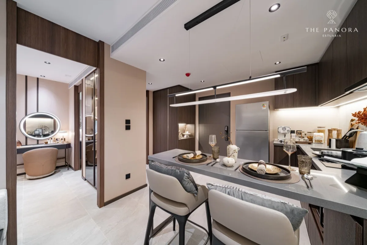 1 Bedroom Condo for Sale at Panora Estuaria: Kitchen dining bar with place settings, leading to a vanity area.