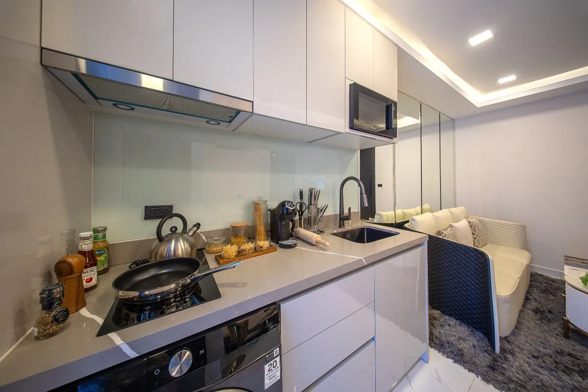 1 Bedroom Condo for Sale at Grand Solaire Noble: Close-up of the modern kitchen counter with sink, stovetop, and microwave.