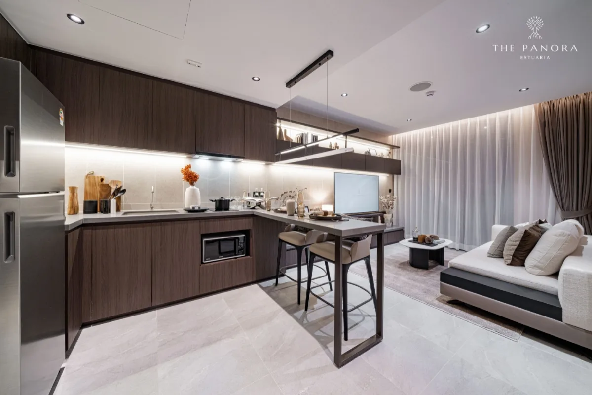 1 Bedroom Condo for Sale at Panora Estuaria: Modern kitchen with dark wood cabinets, stainless steel fridge, and dining bar.