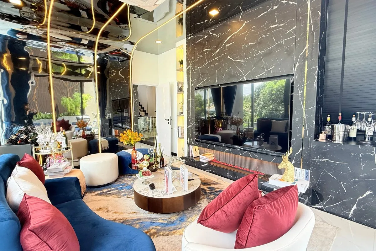 5 Bedroom House for Sale at Harmony Hills Villas Pattaya elegant living room with marble accents, high ceilings, and staircase.