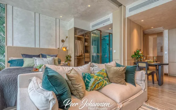 Arom Wongamat: Bedroom with a comfortable bed, sofa, open closet, and a glimpse of the modern bathroom.