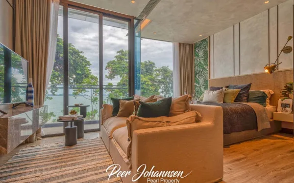 Arom Wongamat: Contemporary bedroom with a sofa, large glass doors, and a stunning ocean view.